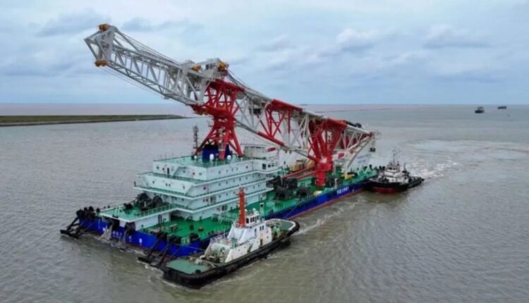 Navio de cravação de estacas com guindaste vermelho navegando
